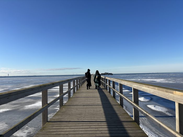 Två personer på bryggan i Bjärred en solig förmiddag